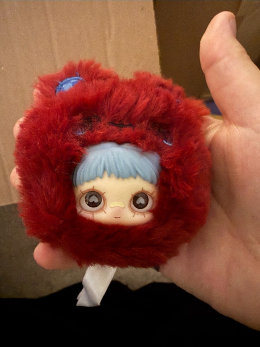 Red Fuzzy Doll Face Keychain with Light Blue Hair